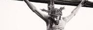 Monochrome depiction of Jesus crucified, showcasing religious artistry and sacrifice.